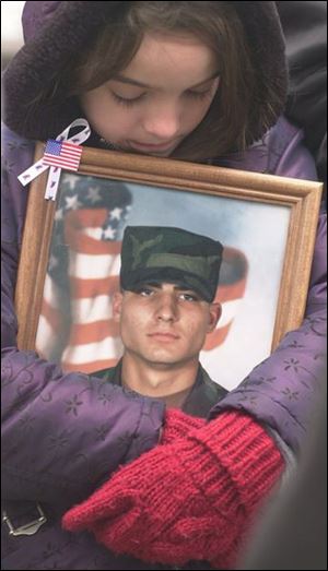 McKenzie Phillips of Swanton holds a photo of her uncle, Rich, who serves in the Army.