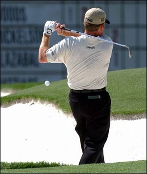 The ball bounces off Jeff Maggert's chest after hitting the lip of the bunker on the third hole. Maggert took a two-stroke penalty and triple-bogeyed the hole.