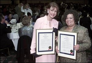 FASHION EXTRAVAGANZA: Cynthia Ford, left, and Annette James display resolutions awarded at banquet.