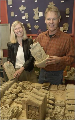 Deb and George Carruth show off some of their garden and architectural accents. They have retail outlets in Waterville and Columbus.