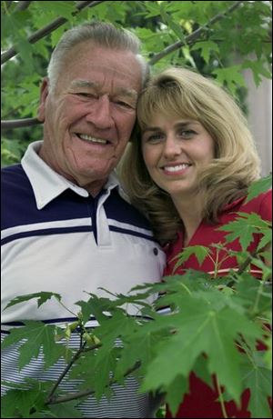 Charles Steele and his granddaughter, Stephanie Christopher, under a maple tree they watched grow.