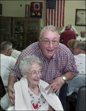 `If any young man takes a fancy to me, I'm just as young as I can be,' says Annie Mitchell, celebrating her 105th birthday with her son, Alfred, during a meeting of union retirees.