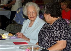 Elizabeth Zepf, left, chats with Kay Flack at the party at Our Lady of Perpetual Help parish.
