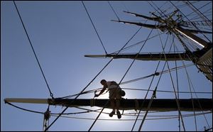 Miami resident Tom Conlon, 21, paints the yard arm of the HMS Bounty as tours of the ship go on far below him. The replica of a 17th-century ship, built in 1960 for the movie Mutiny on the Bounty, was a hit with festival-goers yesterday.