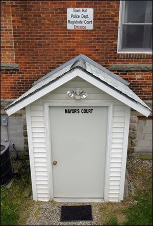 West Millgrove's mayor's court is through a side door and down a ramp into the basement of a multipurpose building.