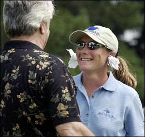 Golfer Karen Stupples puts paper in her ears yesterday as a joke so that she wouldn't have to listen to actor Ron Masek who was in her group during the Owens Corning Pro-Am.