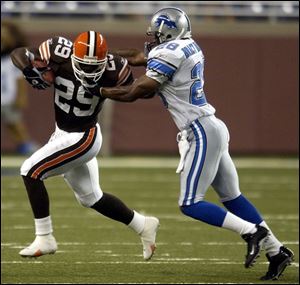 Browns back James Jackson, who had 41 yards on six carries, tries to get away from Lions safety Bracey Wright.