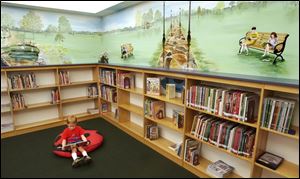 CTY August 27, 2003 - Evan Sandwisch, 5, of Elmore, sits under a mural painted by Denis Bortz in the children's area of the Harris-Elmore Public Library in Elmore.  The mural features sights and children from the community.  Evan is in the mural although on a wall not in the photograph.  Bortz an art teacher at Woodmore Elememtary.  Blade photo by Dave Zapotosky