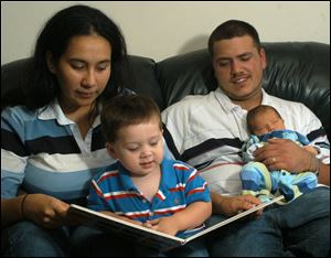 Song-in-the-Night-Sarah Eleanor Mercurio with her husband, Randall, and their sons Jacob Benjamin, 18 months, and Isiah David, 5 weeks. Mrs. Mercurio says she is proud of the bond that her name gives her to her father and his culture.
