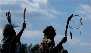 Dancers pause to honor a Bald Eagle as it passes over the Woodland Indian Celebration in Perrysburg,OH. Lisa Dutton 10/05/2003 NBR powow04p 4