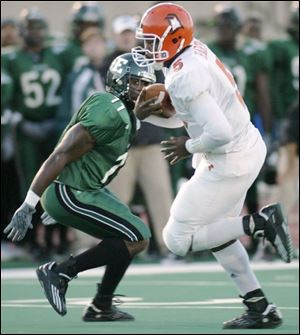 Bowling Green quarterback Josh Harris gets past Eastern Michigan's Jamie Manor on a 20-yard touchdown run in Saturday's 33-20 victory. Harris rushed for 96 yards and three touchdowns as the Falcons piled up 305 yards on the ground.