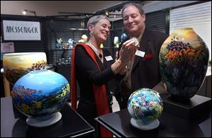 YOU GOTTA HAVE ART: Board chairman Joe Spencer and his wife, Dee, are fired up over pottery during the Artworks Toledo exhibition at the Seagate Centre.