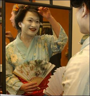 ORIENTAL GRACE: Melissa Wang checks out her hair before she goes out to greet guests at the Sapphire Ball.
