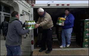 Tim Jelinger, left, Mike Trabbic, and Dave Waingrow unload donations from DaimlerChrysler AG employees at the Cherry Street Mission. Nearly 9 out of 10 cities surveyed say their struggling emergency shelters must turn people away.