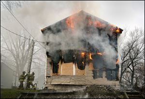 CTY champlain 01 - Toledo firefighters battle a vacant house fire on Champlain St, in which two firefighters were injured. The Blade/Allan Detrich