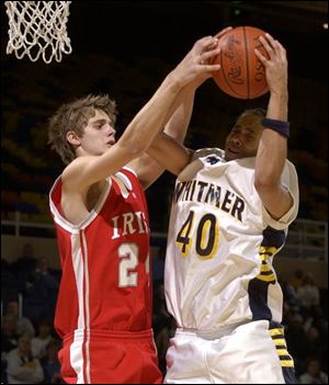 Whitmer's Andre Thompson grabs a rebound from Central Catholic's Steve Phillips. Thompson had 11 rebounds.