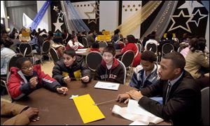 Tommy Gaston, 13, left, shares his career goals with David Paraham, right, a former member of the Toledo Excel program who graduated from the University of Toledo in 2001.