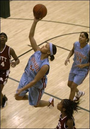 Bowsher s Stephany Johnson glides in for two points in the Rebels  Division I sectional basketball victory over Scott at Clay. Central won the other sectional final played there.