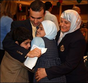 cty match18p 1 March 18, 2004. MCO student Adel Itawi celebrates being matched to the Michigan State residency program with his brother Jad,  sister Sally, and his mother Fayze Thursday at the Great Hall of the Stranahan Theater. Blade photo by Jeremy Wadsworth