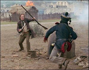 Davy Crockett (Billy Bob Thornton), left, fights off a Mexican soldier in The Alamo.
