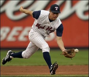 The Mud Hens' Brant Ust charges a ball from third. Ust has also played shortstop, second base and left and right fields, proving to be a very valuable asset.