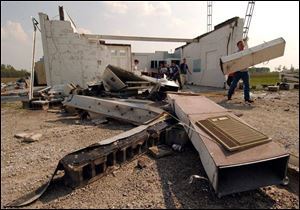 Tadd Baldwin, an emergency medical technician in Continental, Ohio, removes debris.