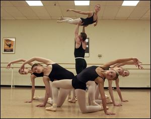 Hilary Sugkowski holds up Jessica Lemons durng a rehearsal of the Toledo Ballet for this weekend's performances.