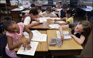 Third graders at Westfield Elementary School work at their lessons. At left is Bre'Shaun Jackson, and at right is Mary Reaves. Both are 9 years old. 