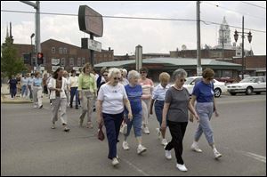 A brisk walk through downtown Napoleon reinforces the group effort in the countywide program to promote good health and fitness. The program, sponsored by the United Way, is in its 12th year, starting as a way to make up for not having a YMCA in town.