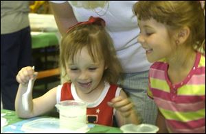 NBR  Alisa Shelt, 3, of Wauseon, Ohio has added so much salt to a beaker of water that she has enabled a golf ball to float. It was one of the science experiments that were offered by the outreach department of Ann Arbor, Michigan's 