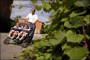 William Ashley, 51, goes for a morning walk with his 1-year-old twin daughters, Samantha and Emily.