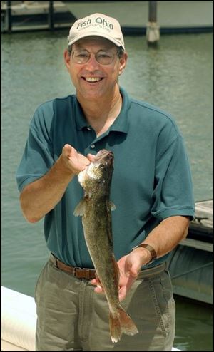 Gov. Bob Taft displays one of the four walleye he caught during the 26th annual Governor's Lake Erie Fish Ohio Day, an annual event started by former Gov. James Rhodes in part to promote preservation of the lake's natural resources.