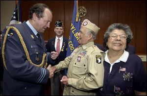 Brig. Gen. Dany Van de Ven jokes with Guadalupe Flores and his wife, Maria, after Mr. Flores was presented with the Fourragere, one of Belgium's most prestigious awards, for his military service. Mr. Flores participated in the Battle of the Bulge.