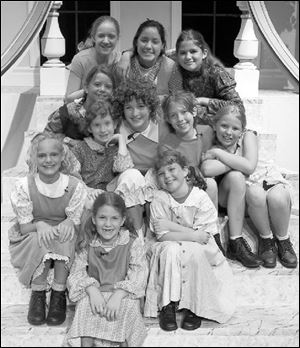 For the Fountain City Festival's production of Annie, the orphans are played by (from left, starting with the front row) Emily Grisier, Megan Steel, and Sarah Elting; second row: Brittany Kolb (hand under chin), Kristen Kurivial as Annie, Jessica Stark, and Melissa Tippin; third row: Alexa Jones; back row: Aubry Hagadorn, Shana Flores, and Maddy Plouck. Missing is Danielle Delgado.