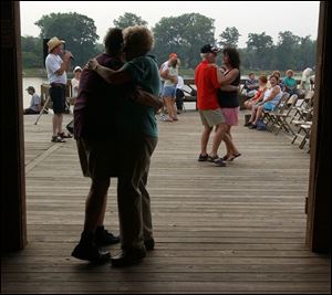 NBR SUNSET21P 2 7/21/04 PHOTO BY LORI KING Couples dance to the music of Bob Wurst at Olander Park. (PS NO SUNSET. CLOUDY)