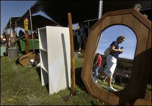 CTY stony24p A  July 24, 2004-- Joyce Barta, Rossford, is reflected in a mirror as she shops the flea market at the Stoney Ridge Summer Fair Saturday. Blade photo by Andy Morrison