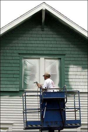 The thick liquid goes onto the exterior of a house much like traditional paint.