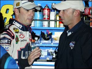 Jimmie Johnson, left, talks with his crew chief, Chad Knaus. He leads in points but that doesn't mean as much this season.