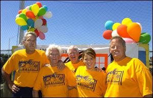 PLAY BALL: From left, are Dan Hylant, Jeanne Hylant-Schoen and Dick Schoen, and Sarah and Geof Tracy.