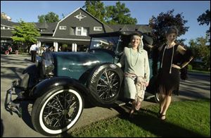 ROARING GOOD TIMES: Jane Gensler and Michelle Thomas are all dressed up in 'Flapper' outfits for the Gatsby Gala, standing next to a Gatsby-era automobile.