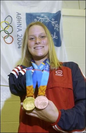 Beth Riggle shows off her medals - gold in the 400 medley relay, bronze in the 100 breaststroke - from the Paralympic Games.