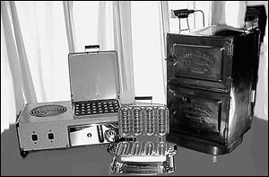 Toledo-made appliances from left: Swartzbaugh Manufacturing Co.'s burner/boiler/grill/toaster combo and Wal-Fill Baker; the Ohio Steam Cooker patented by Toledo Cooker Co.