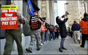 Marchers assemble outside the building that houses the Toledo offices of the federal wages and hours bureau.