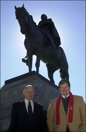 Richard Micka, left, of the Little Bighorn Associates, and John Patterson of the Monroe County Convention & Tourism Bureau stand by a statue of Gen. George Armstrong Custer, who lived in Monroe for 26 years. Custer Week raises interest and some controversy.