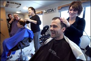 CTY haircut11p  Oct. 11, 2004-- Hobart Thornton, smiles as Amanda Connors finishes cutting his hair. Mr. Thornton and others were getting free haircuts by local beauticians in a 34-foot motor home as part of Project Daymaker. Blade photo by Andy Morrison