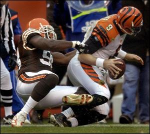 The Browns' Ebenezer Ekuban sacks Cincinnati quarterback Carson Palmer in the fourth quarter. The Bengals had just 58 yards rushing.