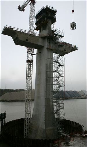 Rov pylon 1 .jpg a cement bucket goes up to serve the bridge pylon. blade photo by herral long 10/18/2004