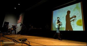 Nathan Sayre helps convert the Springfield High School auditorium into the Vineyard Church of Toledo for Sunday service.