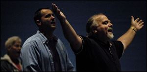 The Rev. Bill Herzog sings during a Vineyard Church service in Springfield High School.