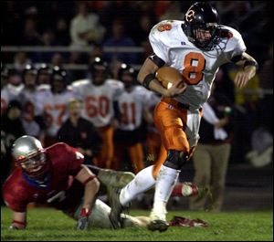 Liberty Center quarterback Brian Babcock breaks free against the Patrick Henry defense.